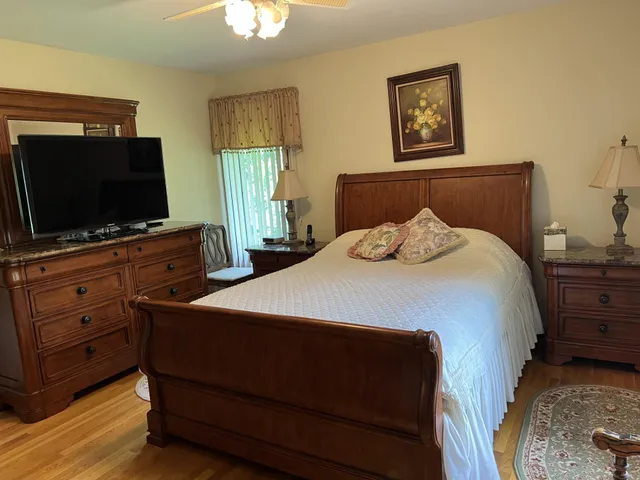 a bedroom with a bed and a flat screen tv