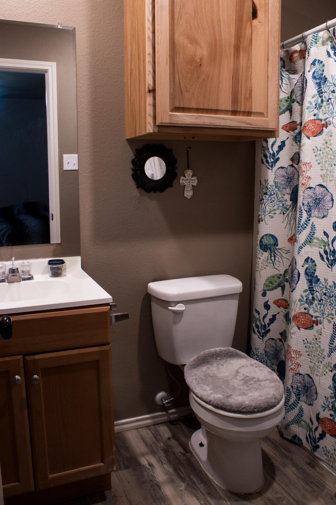 211 42nd Street, Unit 2 Lubbock, TX 79404 - Photo 5 of 9 a bathroom with a toilet sink and mirror