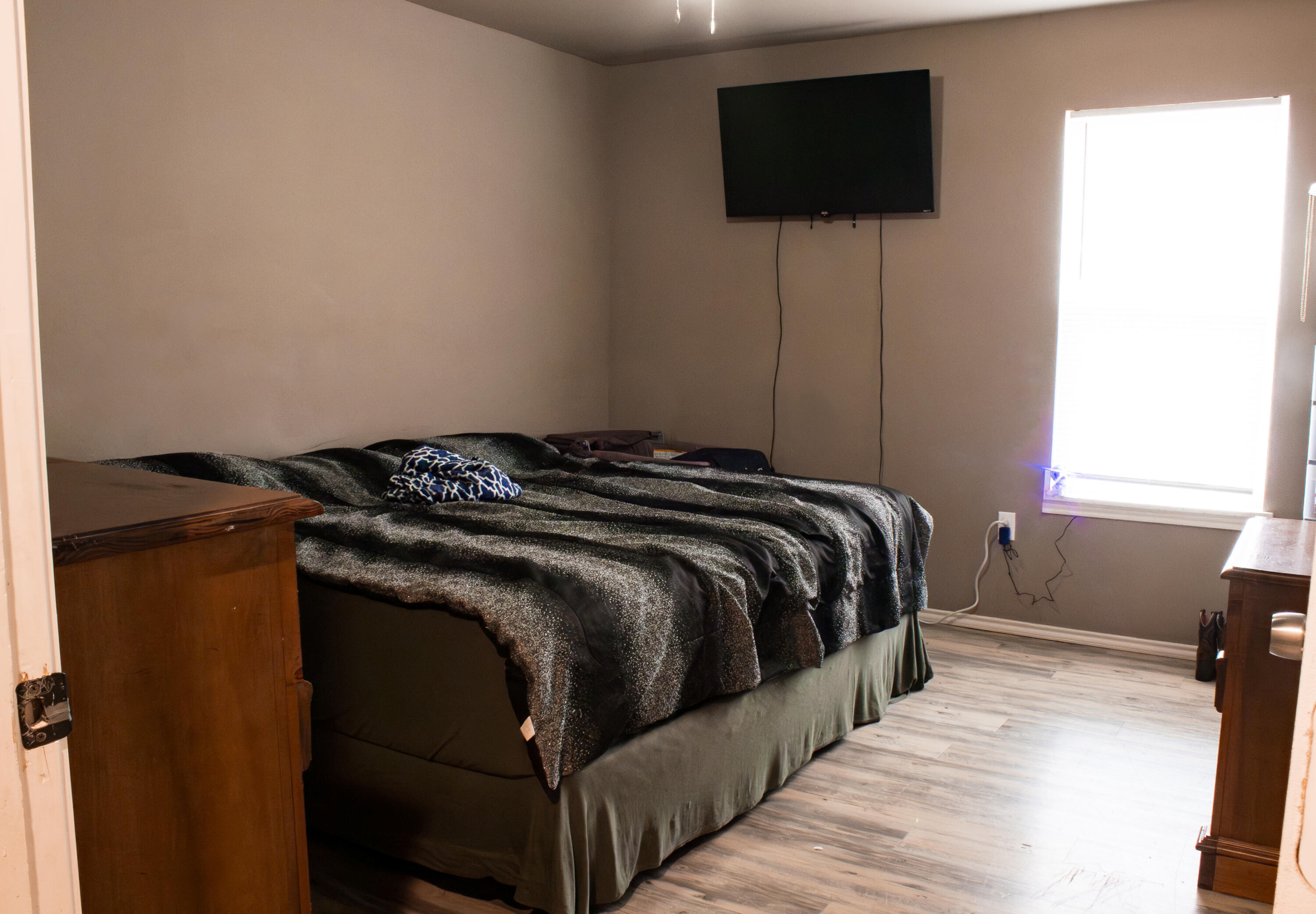 211 42nd Street, Unit 2 Lubbock, TX 79404 - Photo 6 of 9 a bedroom with a bed and a flat screen tv