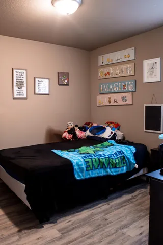 a bed room with a bed and a chair