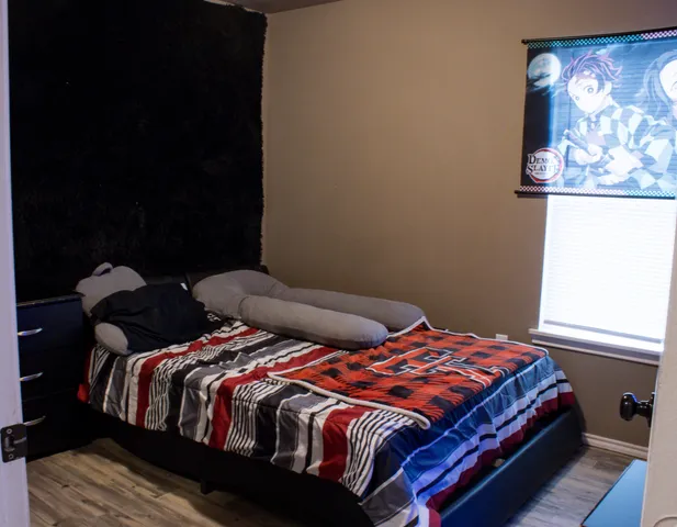 a bedroom with a bed and a window