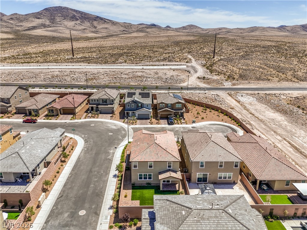 3782 Alla Rocca Avenue Henderson, NV 89044 - Photo 48 of 55 This aerial view showcases a residential community nestled against a majestic mountain backdrop.