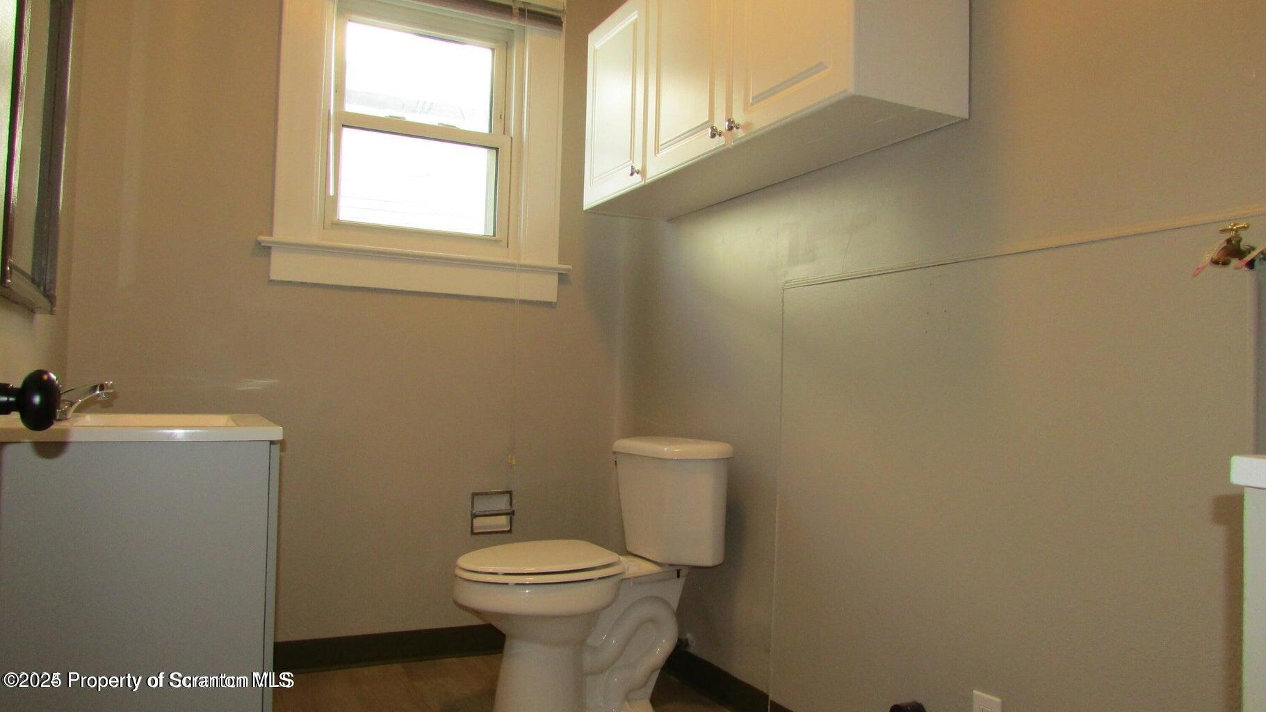 217 Crown Avenue Scranton, PA 18505 - Photo 18 of 25 a white toilet sitting next to a bathroom sink
