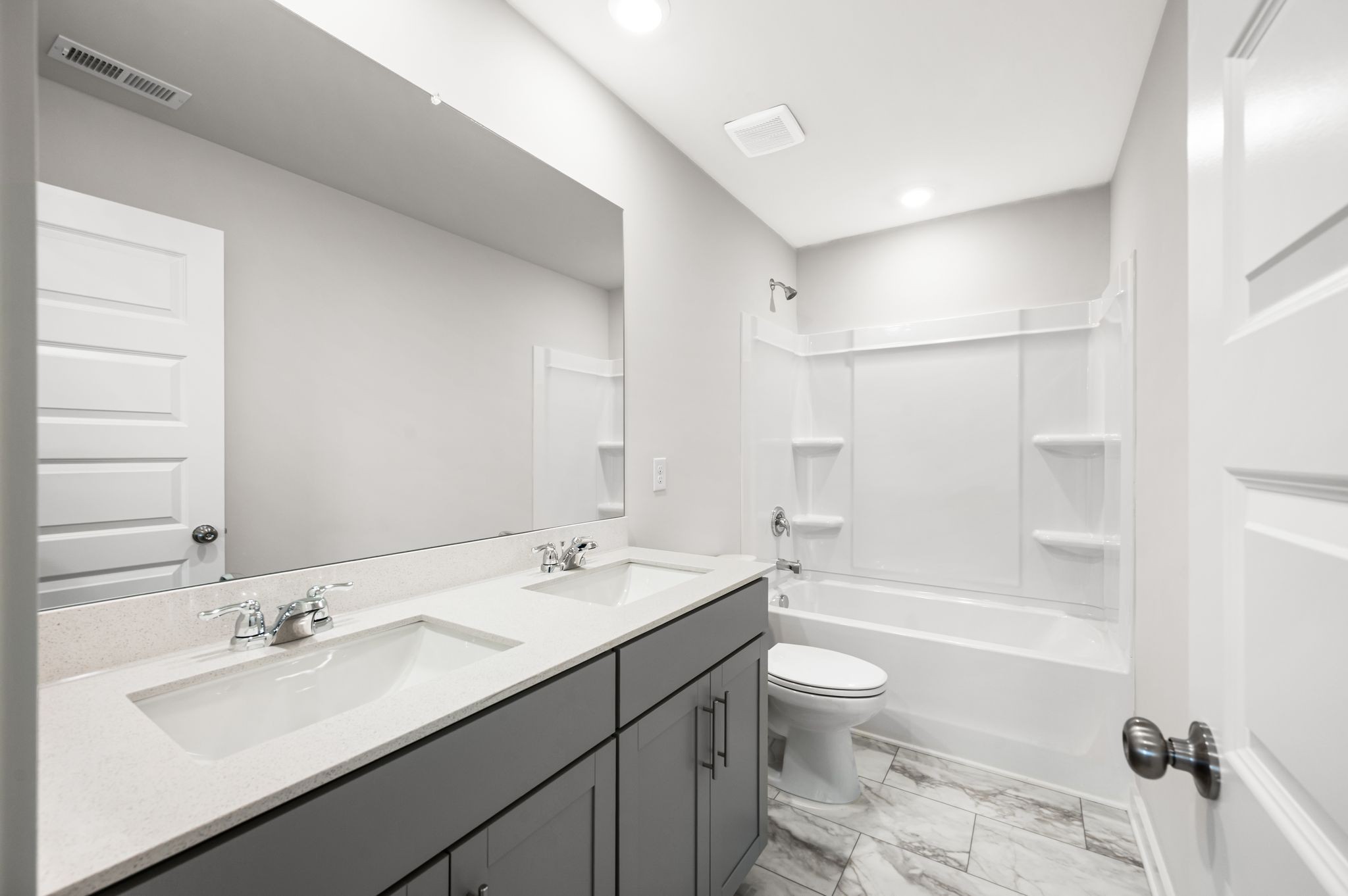 1019 Curtis Spring Lane Lewisburg, TN 37091 - Photo 22 of 23 a bathroom with a double vanity sink toilet mirror and bathtub
