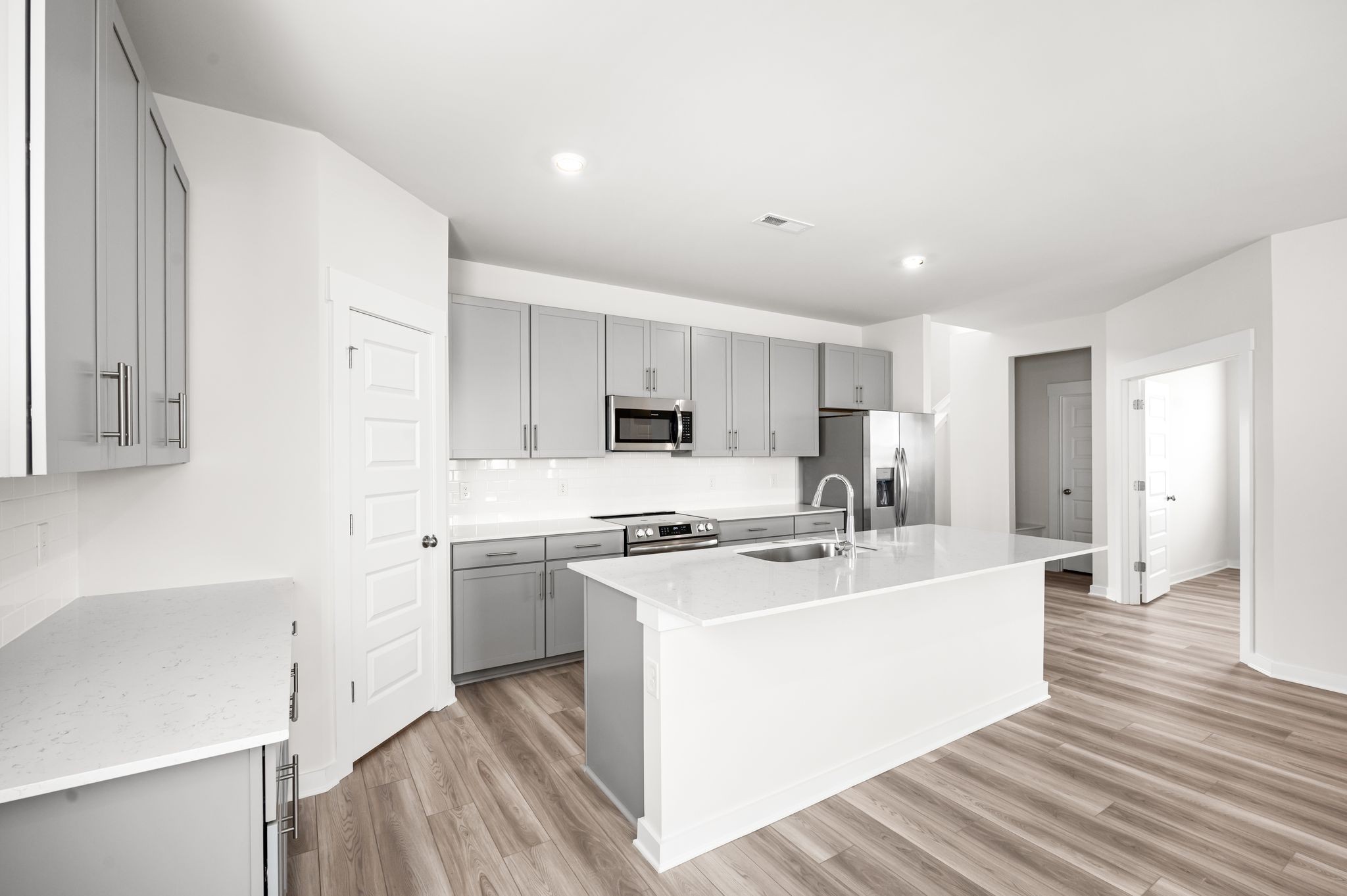 1019 Curtis Spring Lane Lewisburg, TN 37091 - Photo 9 of 23 a kitchen with stainless steel appliances a sink a stove a refrigerator cabinets and a center island