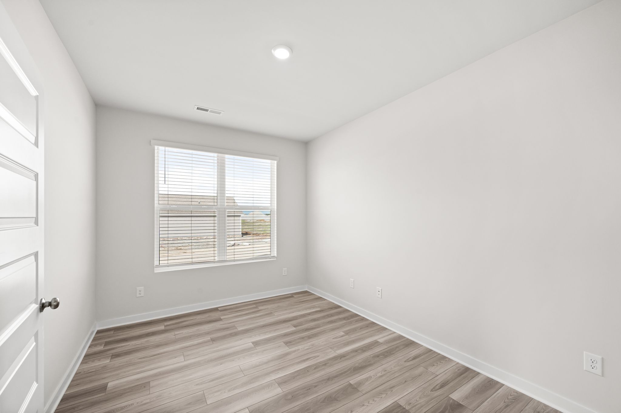1019 Curtis Spring Lane Lewisburg, TN 37091 - Photo 10 of 23 an empty room with wooden floor and windows