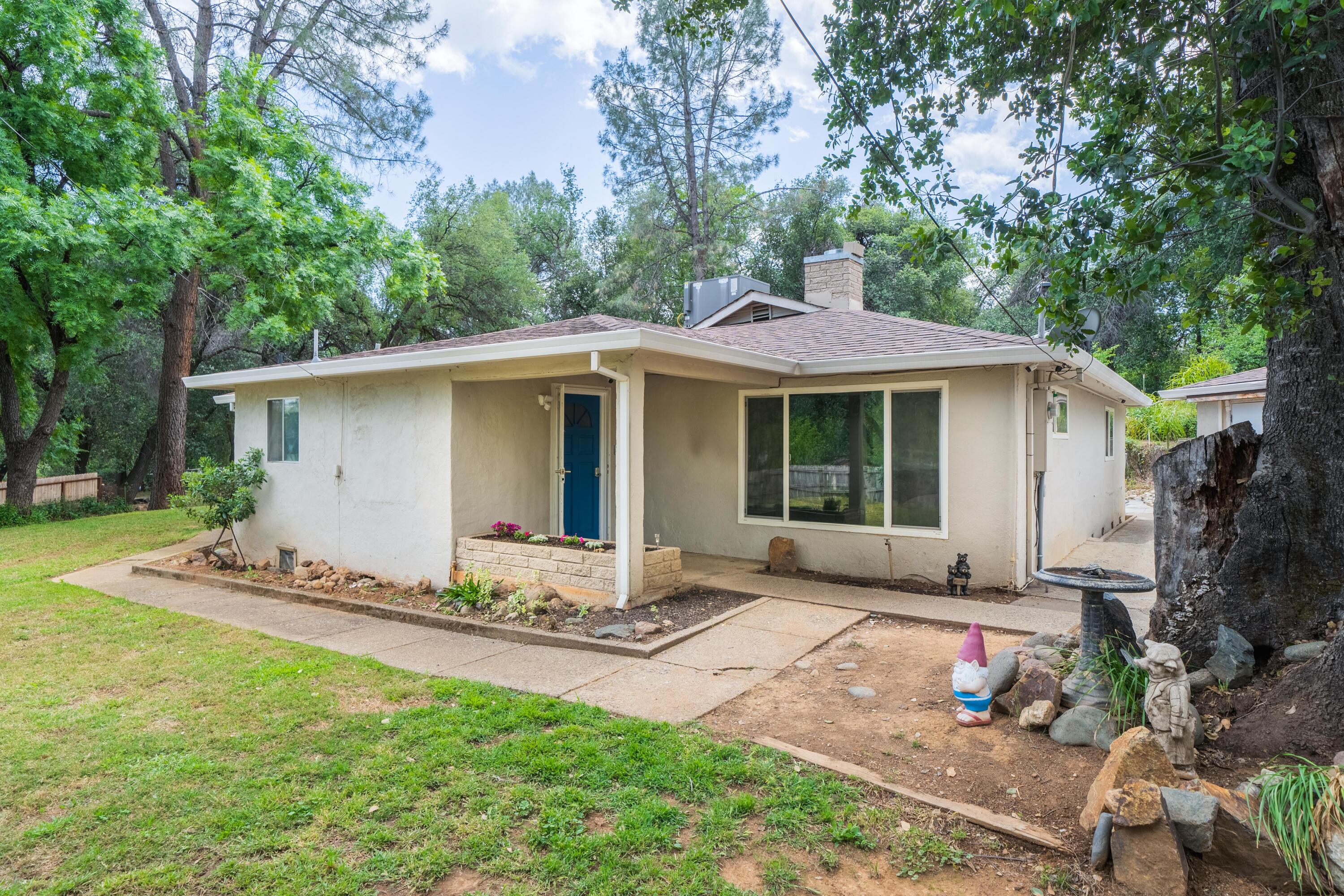 3113 Quartz Hill Road Redding, CA 96003 - Photo 1 of 36 a front view of a house with a garden and yard