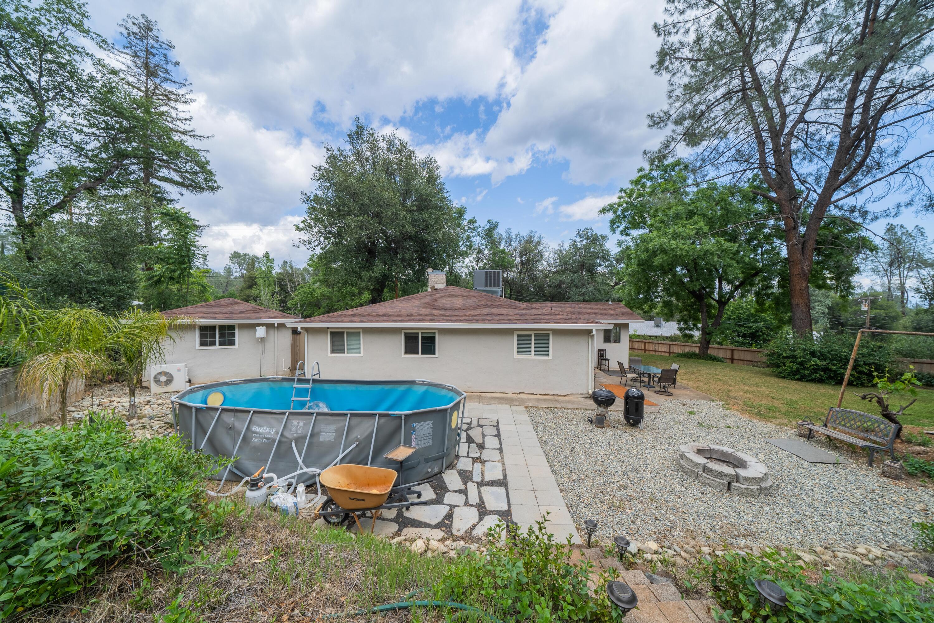 3113 Quartz Hill Road Redding, CA 96003 - Photo 24 of 36 a view of a house with a yard and sitting area