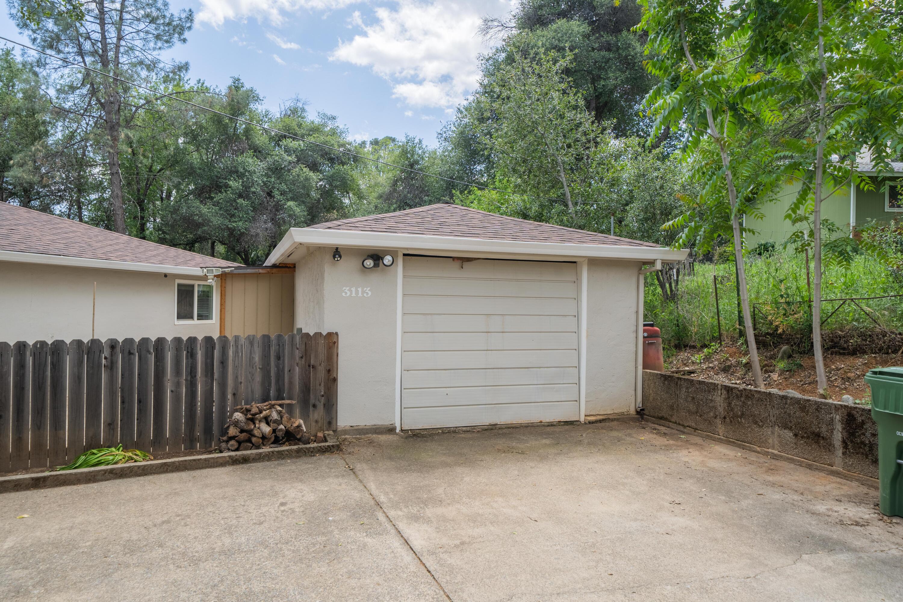 3113 Quartz Hill Road Redding, CA 96003 - Photo 3 of 36 a view of a house with a garage and yard