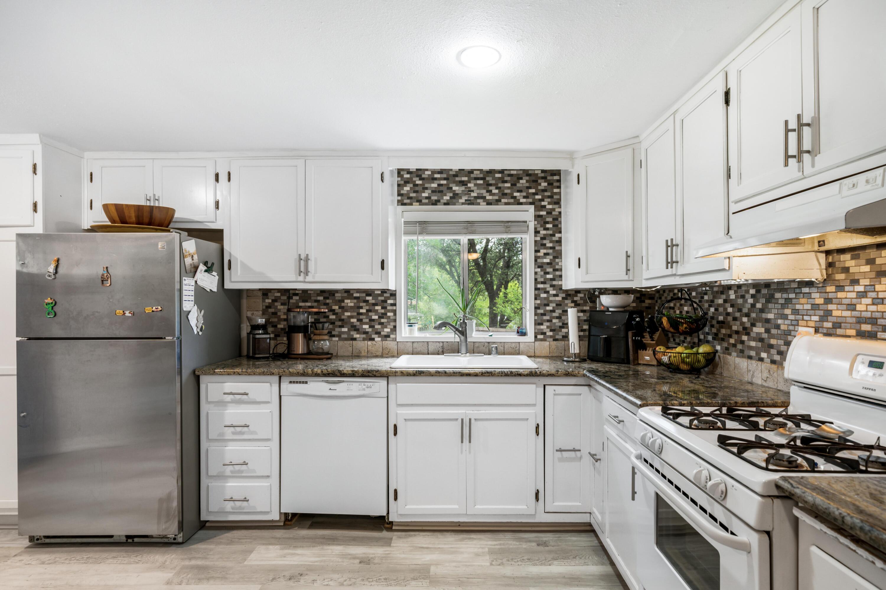 3113 Quartz Hill Road Redding, CA 96003 - Photo 9 of 36 a kitchen with white cabinets and appliances