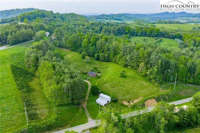 a view of a lush green hillside and a building