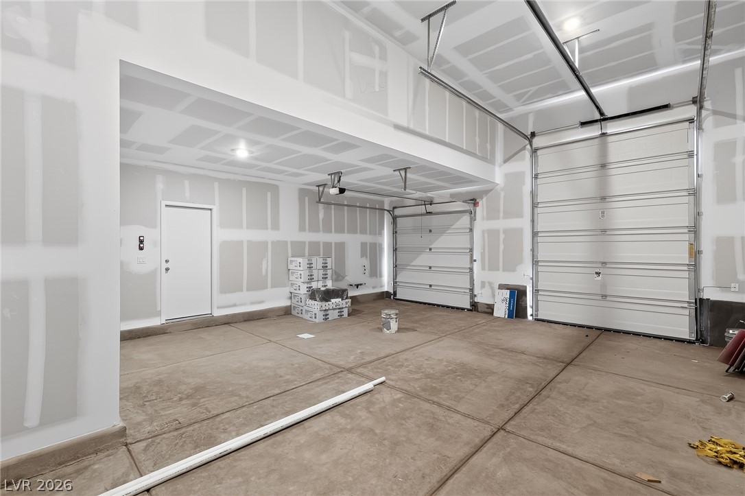 347 Sam Way Mesquite, NV 89027 - Photo 26 of 32 A spacious, unfinished garage awaits customization, offering ample parking and storage.