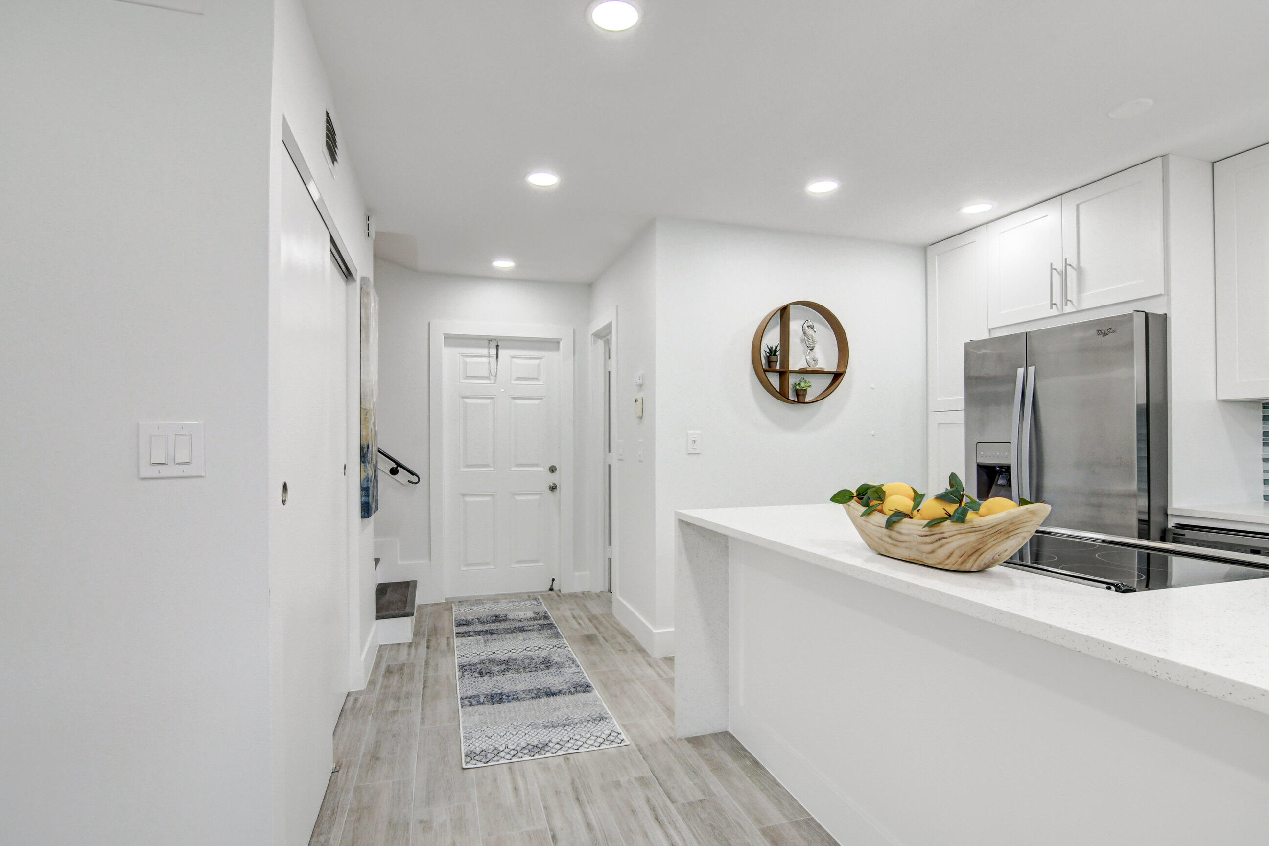 5720 Old Ocean Boulevard, Unit 4W Ocean Ridge, FL 33435 - Photo 12 of 46 a hallway with table and chairs