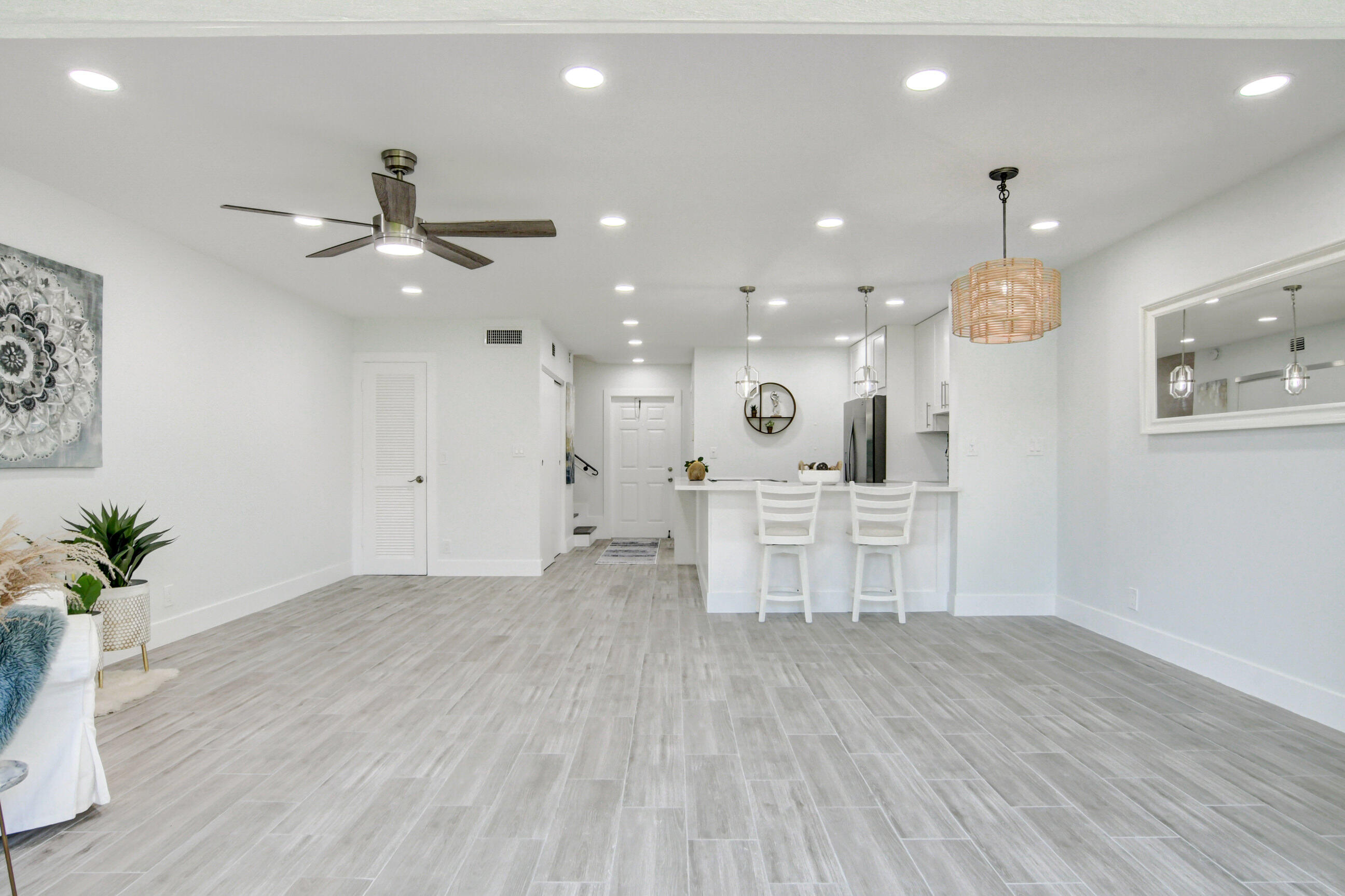5720 Old Ocean Boulevard, Unit 4W Ocean Ridge, FL 33435 - Photo 15 of 46 a view of an empty room and kitchen with wooden floor