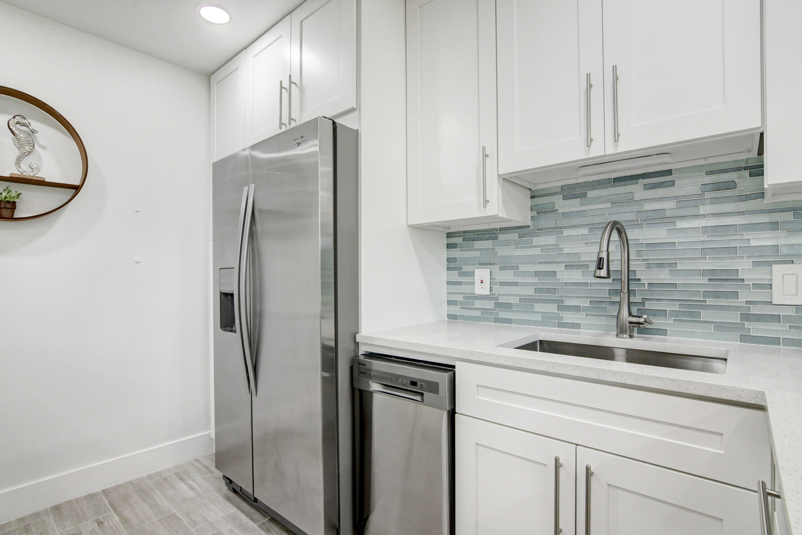 5720 Old Ocean Boulevard, Unit 4W Ocean Ridge, FL 33435 - Photo 18 of 46 a kitchen with stainless steel appliances granite countertop a refrigerator and a sink