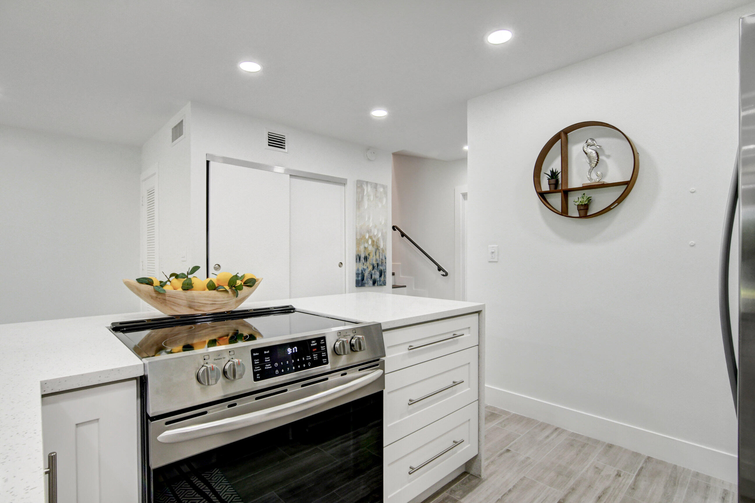 5720 Old Ocean Boulevard, Unit 4W Ocean Ridge, FL 33435 - Photo 19 of 46 a kitchen with a stove and a clock