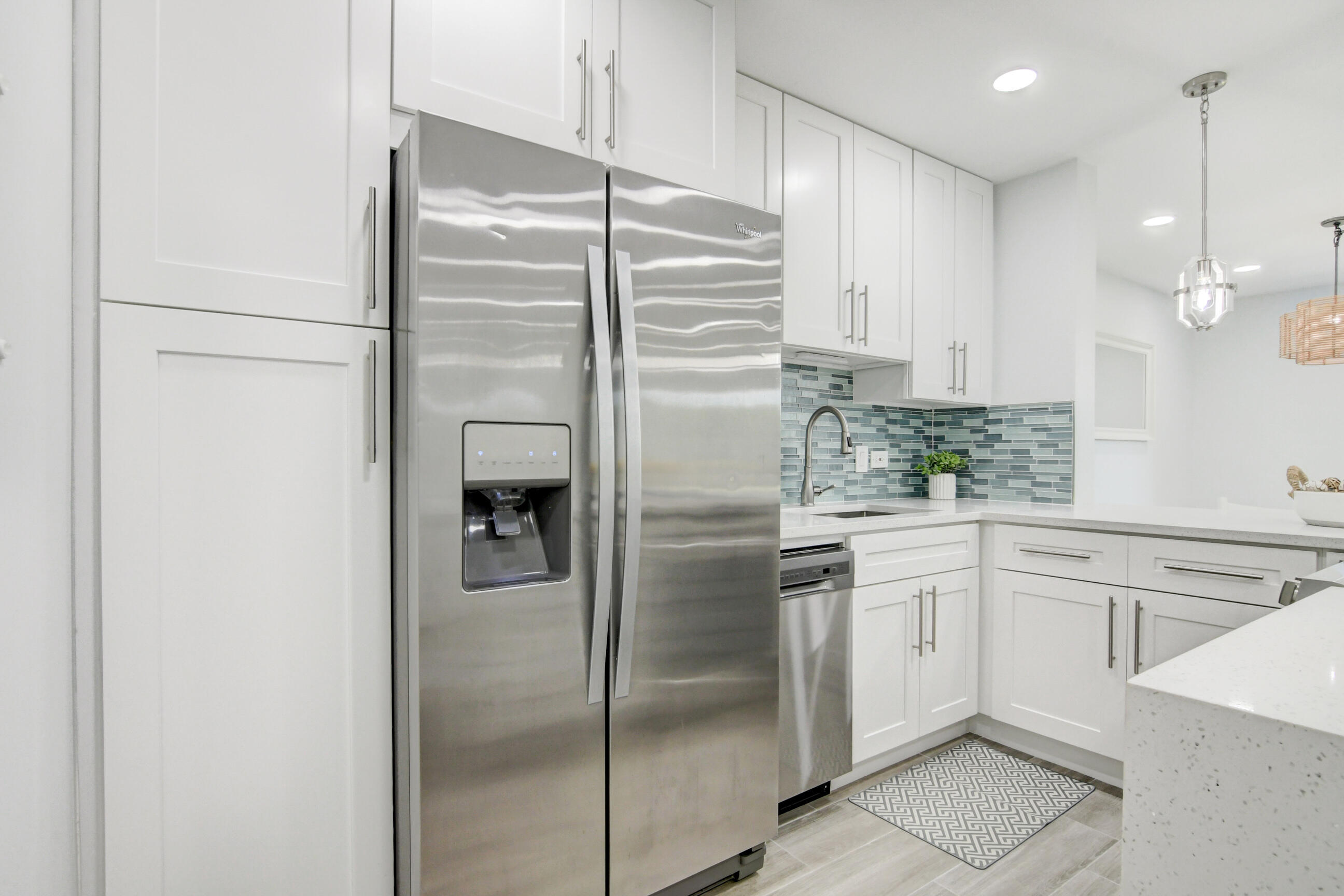 5720 Old Ocean Boulevard, Unit 4W Ocean Ridge, FL 33435 - Photo 20 of 46 a kitchen with stainless steel appliances granite countertop a refrigerator and a sink