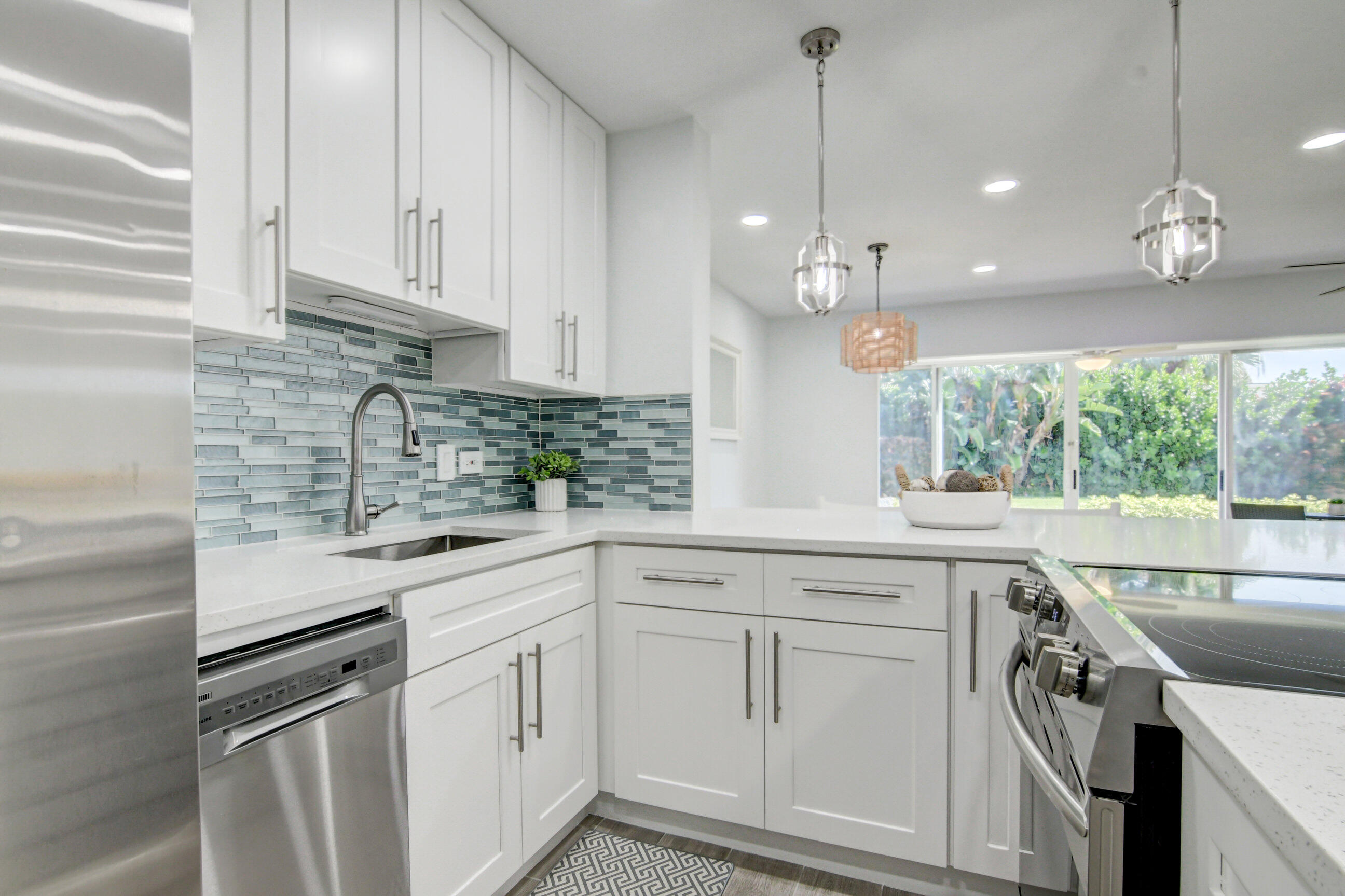 5720 Old Ocean Boulevard, Unit 4W Ocean Ridge, FL 33435 - Photo 21 of 46 a kitchen with white cabinets and white appliances