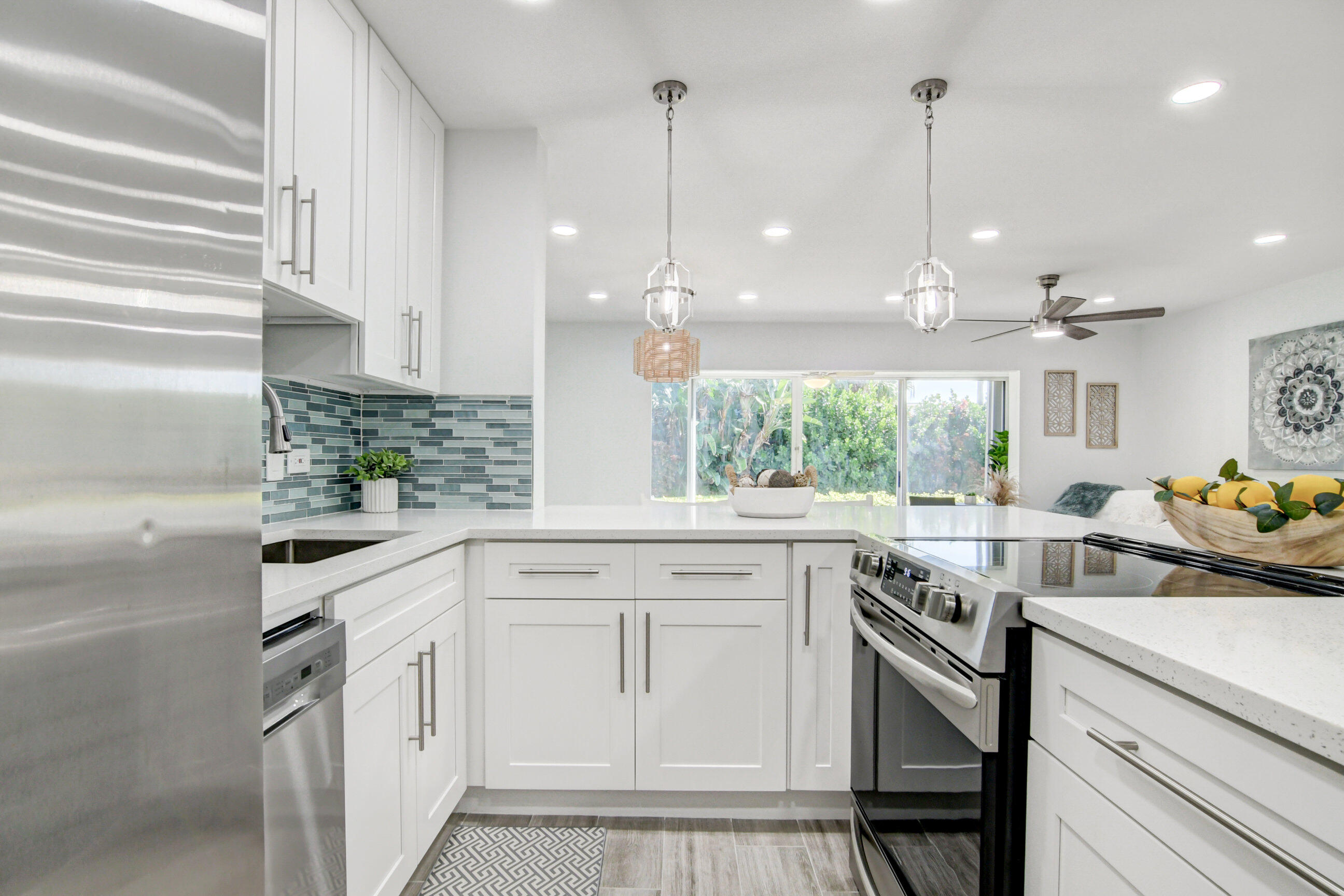 5720 Old Ocean Boulevard, Unit 4W Ocean Ridge, FL 33435 - Photo 22 of 46 a kitchen with white cabinets and appliances