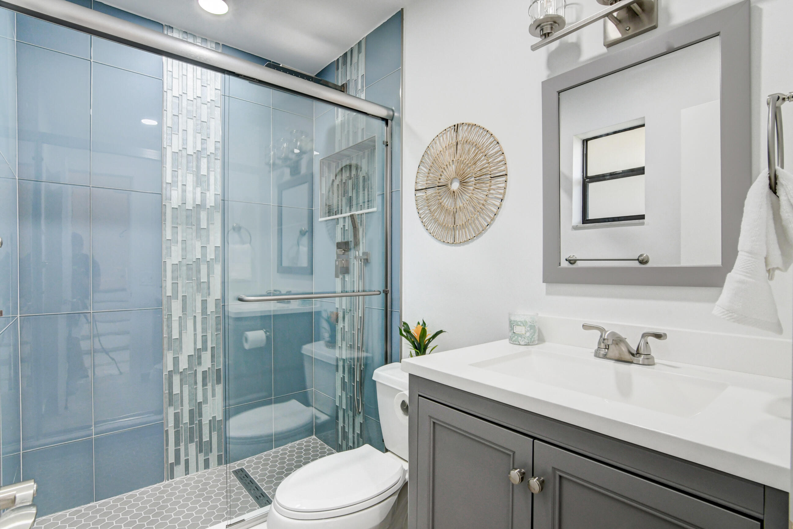 5720 Old Ocean Boulevard, Unit 4W Ocean Ridge, FL 33435 - Photo 28 of 46 a bathroom with a sink a toilet and shower