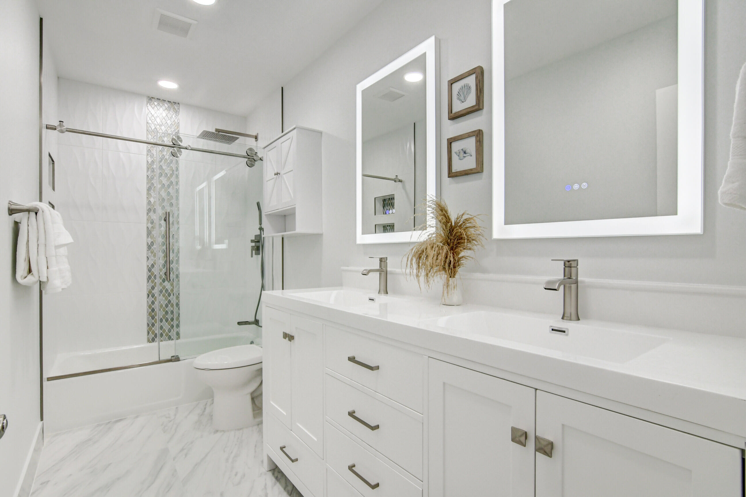 5720 Old Ocean Boulevard, Unit 4W Ocean Ridge, FL 33435 - Photo 29 of 46 a bathroom with a double vanity sink toilet and shower