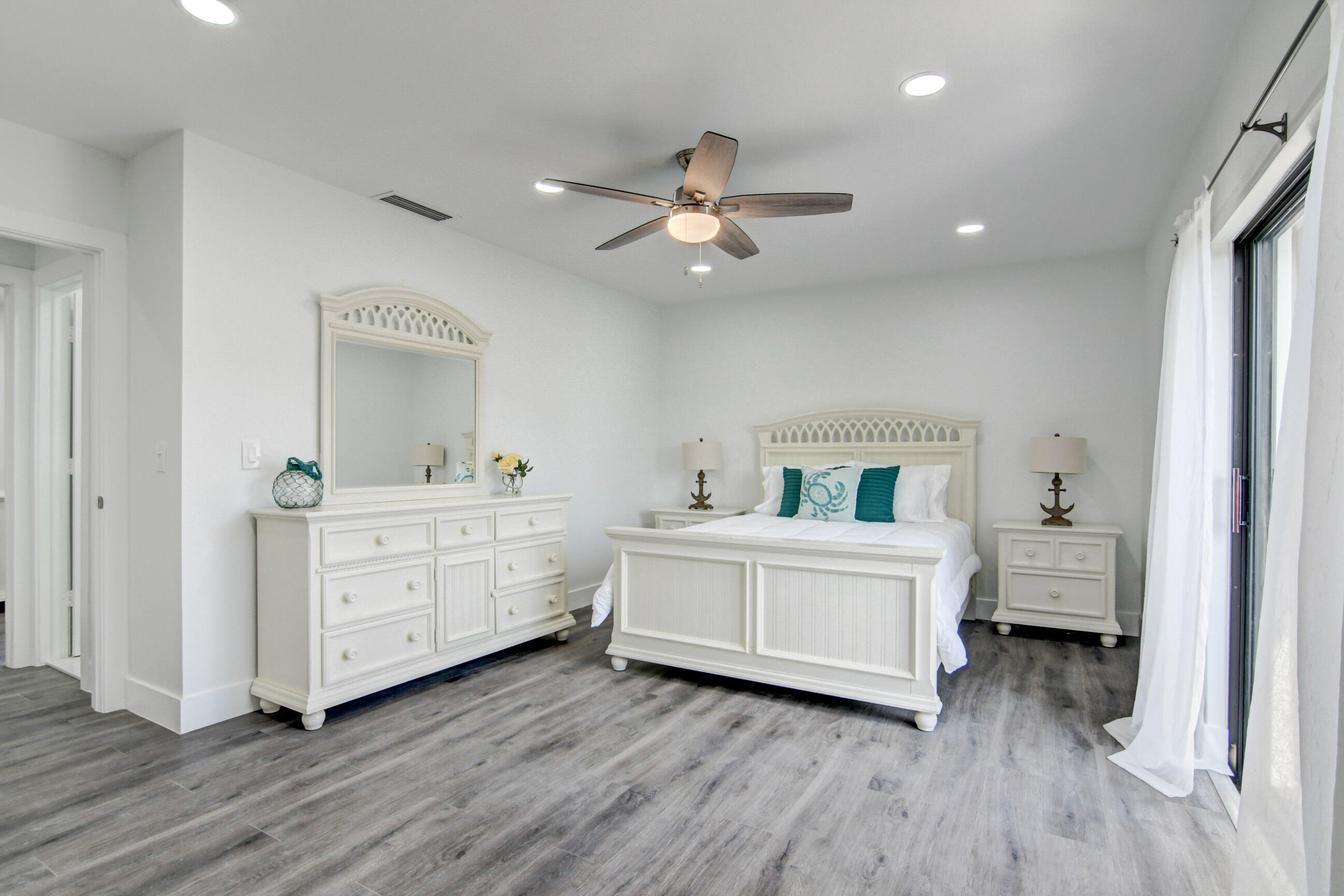 5720 Old Ocean Boulevard, Unit 4W Ocean Ridge, FL 33435 - Photo 31 of 46 a room with a baby bed baby crib and a dresser
