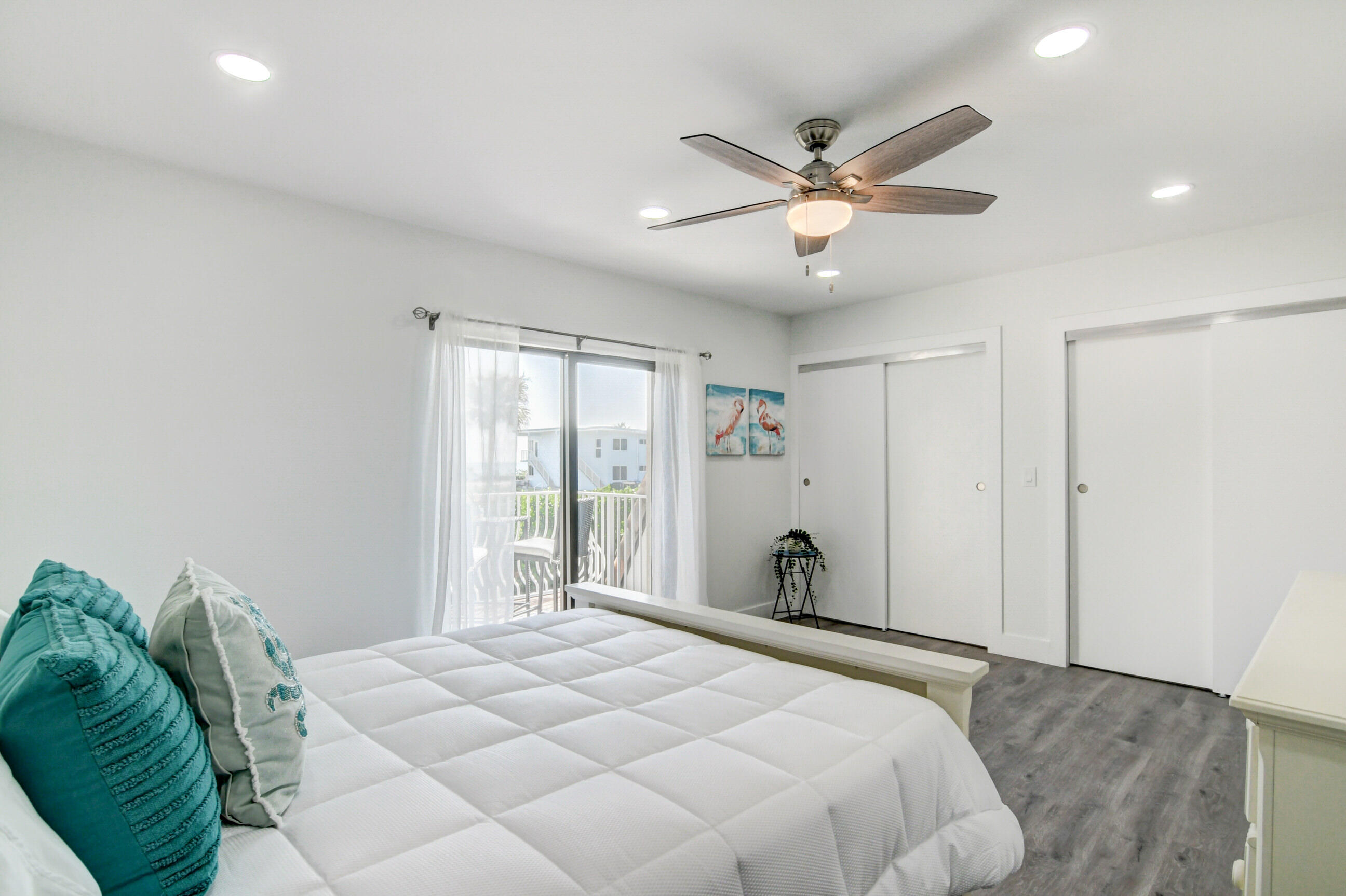 5720 Old Ocean Boulevard, Unit 4W Ocean Ridge, FL 33435 - Photo 32 of 46 a bedroom with a large bed and a chandelier