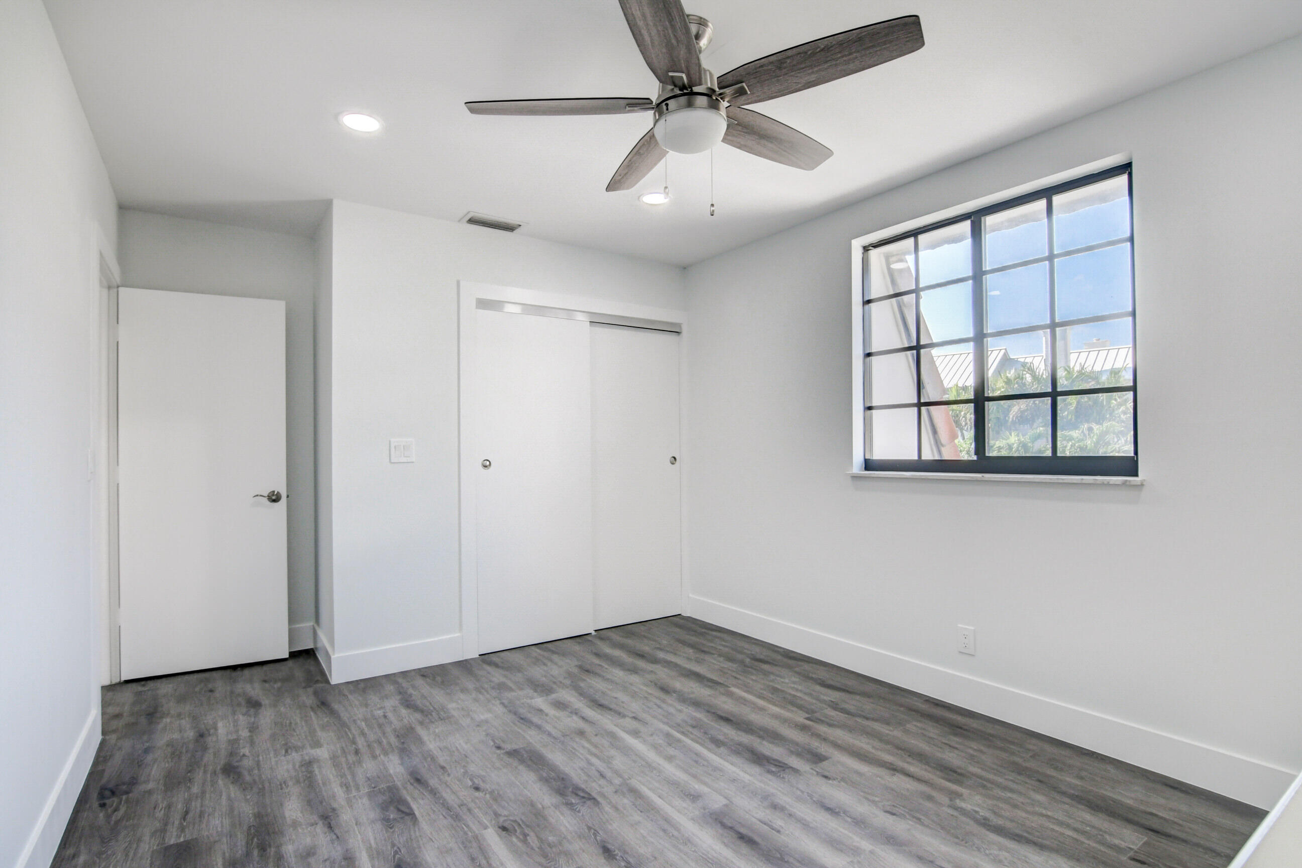 5720 Old Ocean Boulevard, Unit 4W Ocean Ridge, FL 33435 - Photo 34 of 46 wooden floor in an empty room with a window