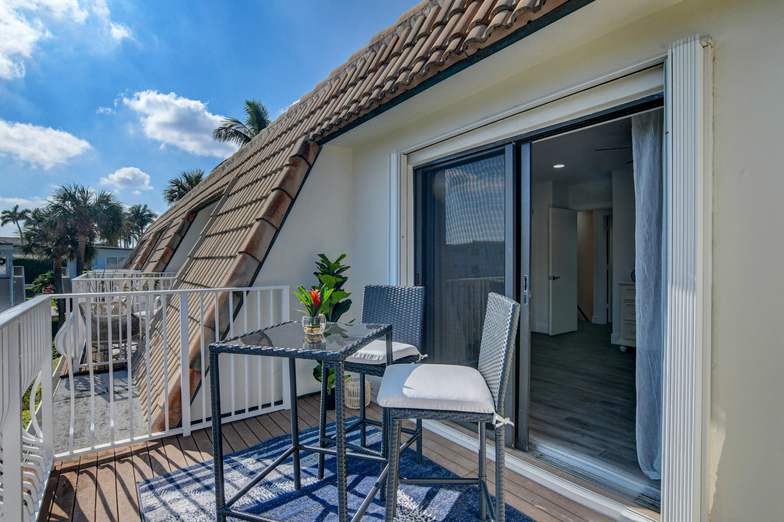 5720 Old Ocean Boulevard, Unit 4W Ocean Ridge, FL 33435 - Photo 40 of 46 a balcony with table and chairs