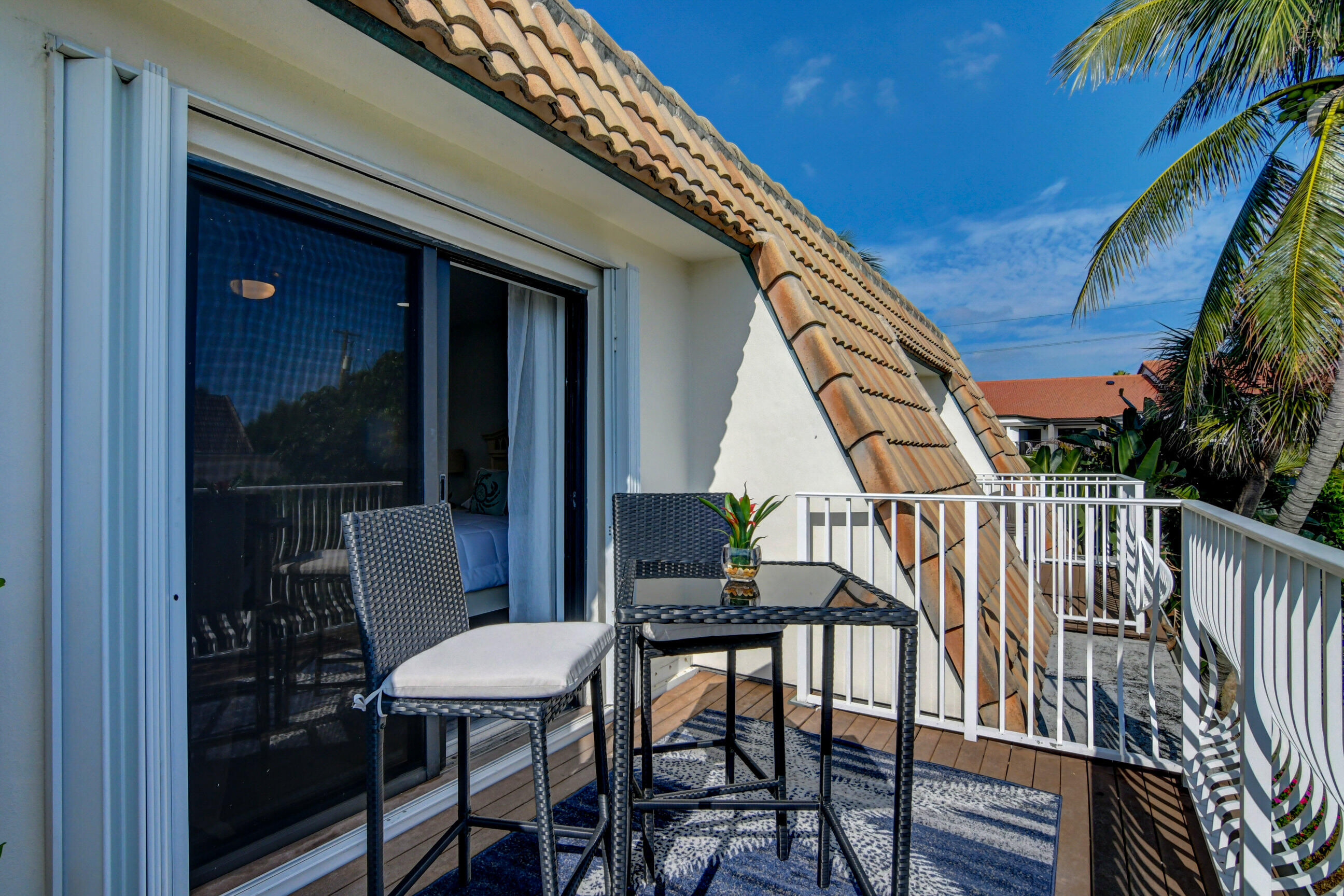 5720 Old Ocean Boulevard, Unit 4W Ocean Ridge, FL 33435 - Photo 41 of 46 a balcony with table and chairs