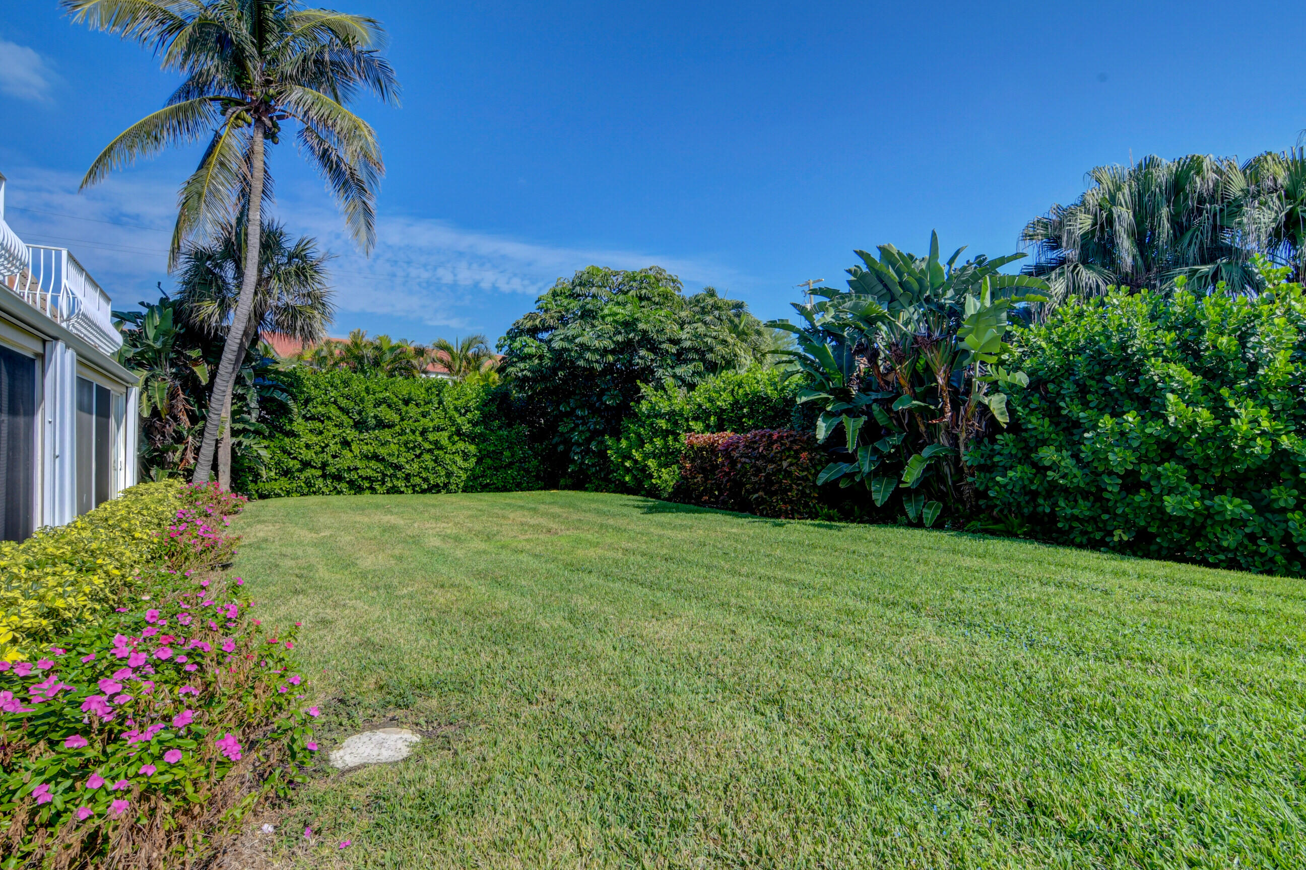 5720 Old Ocean Boulevard, Unit 4W Ocean Ridge, FL 33435 - Photo 43 of 46 a view of a garden with a house