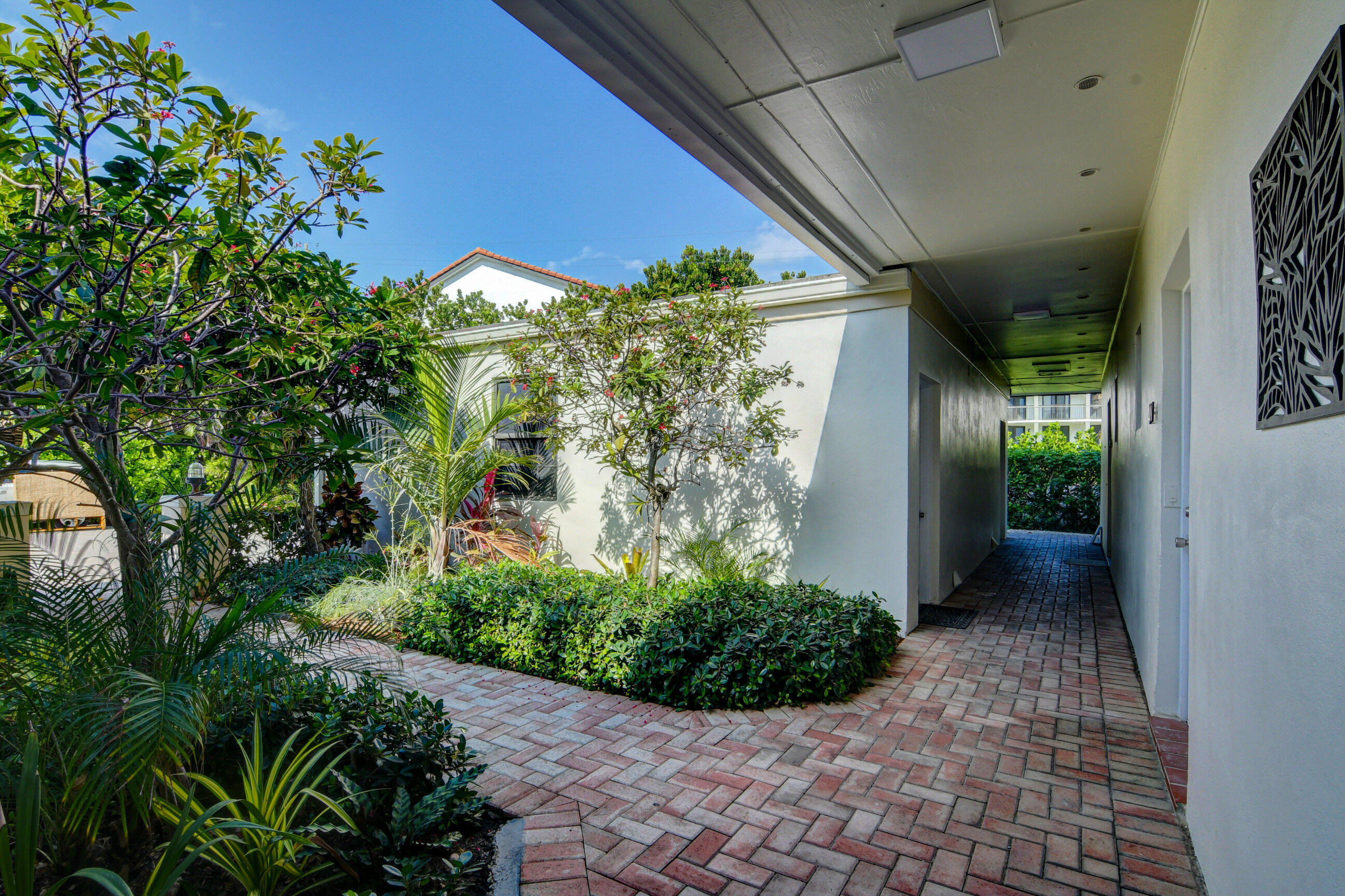 5720 Old Ocean Boulevard, Unit 4W Ocean Ridge, FL 33435 - Photo 7 of 46 a view of a pathway both side of house