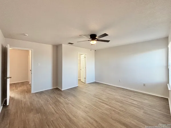 a view of an empty room with wooden floor