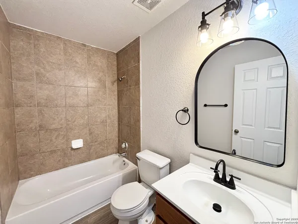 a bathroom with a sink a toilet and a bathtub