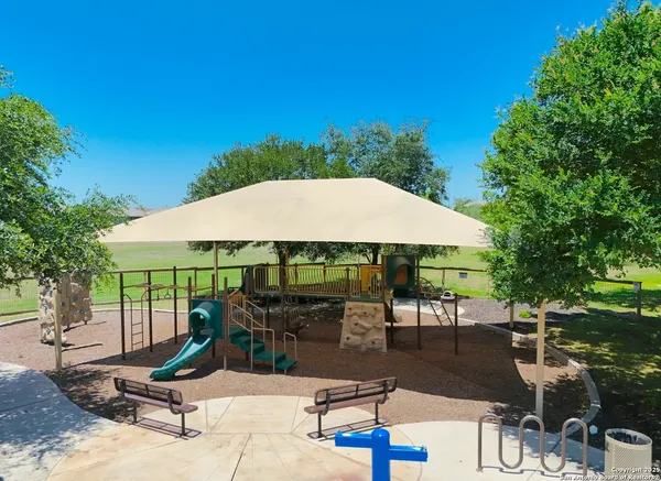 a view of backyard with outdoor seating and trees
