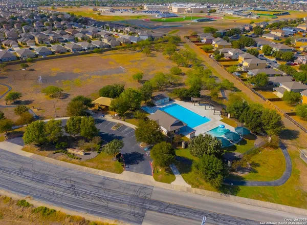 an aerial view of residential houses with outdoor space