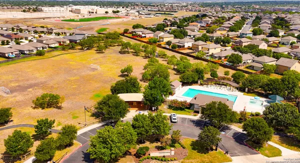 an aerial view of residential houses with outdoor space