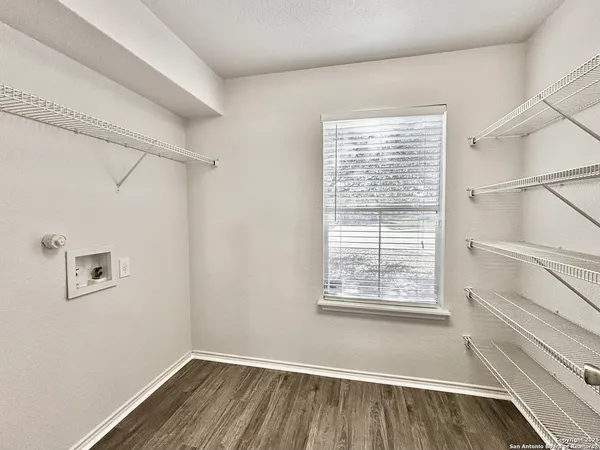 a view of a room with racks on the wall and a window