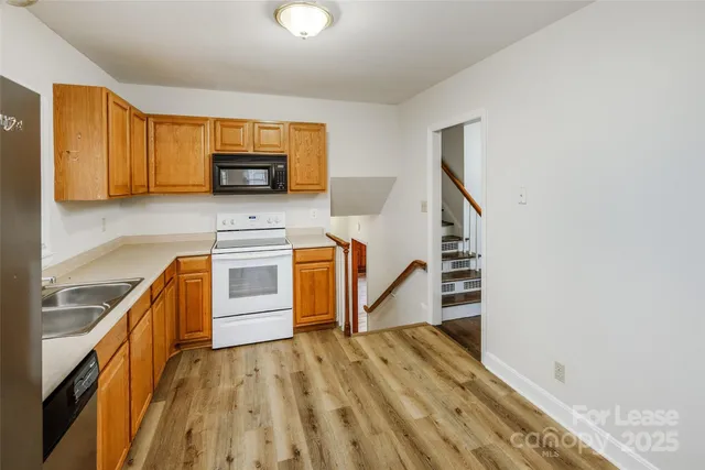 a kitchen with stainless steel appliances granite countertop a stove and a sink