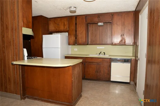 a kitchen with a sink and a stove top oven