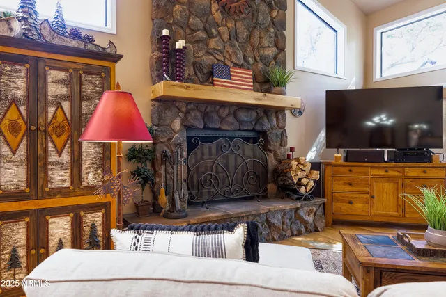 a living room with furniture a fireplace and a flat screen tv