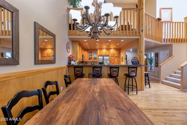 a view of a dining area with furniture and a chandelier