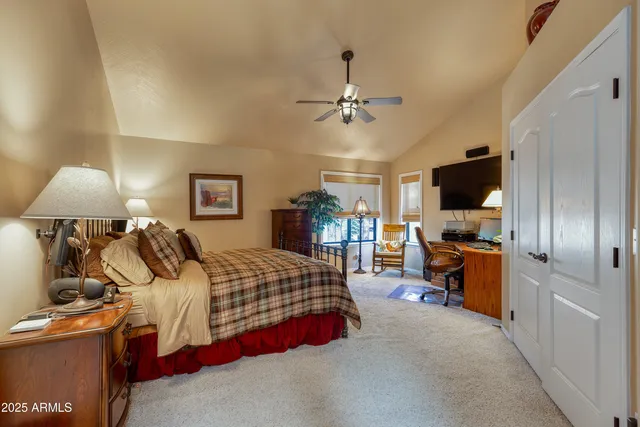 a living room with furniture a rug and kitchen view