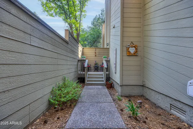 a view of a lush green forest with a building in the background