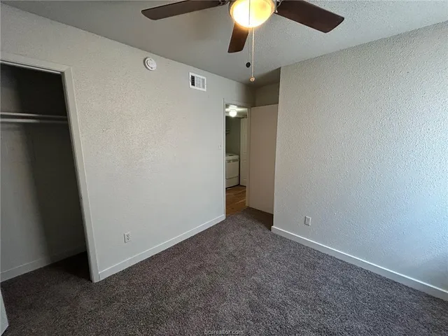 an empty room with a empty space and a ceiling fan