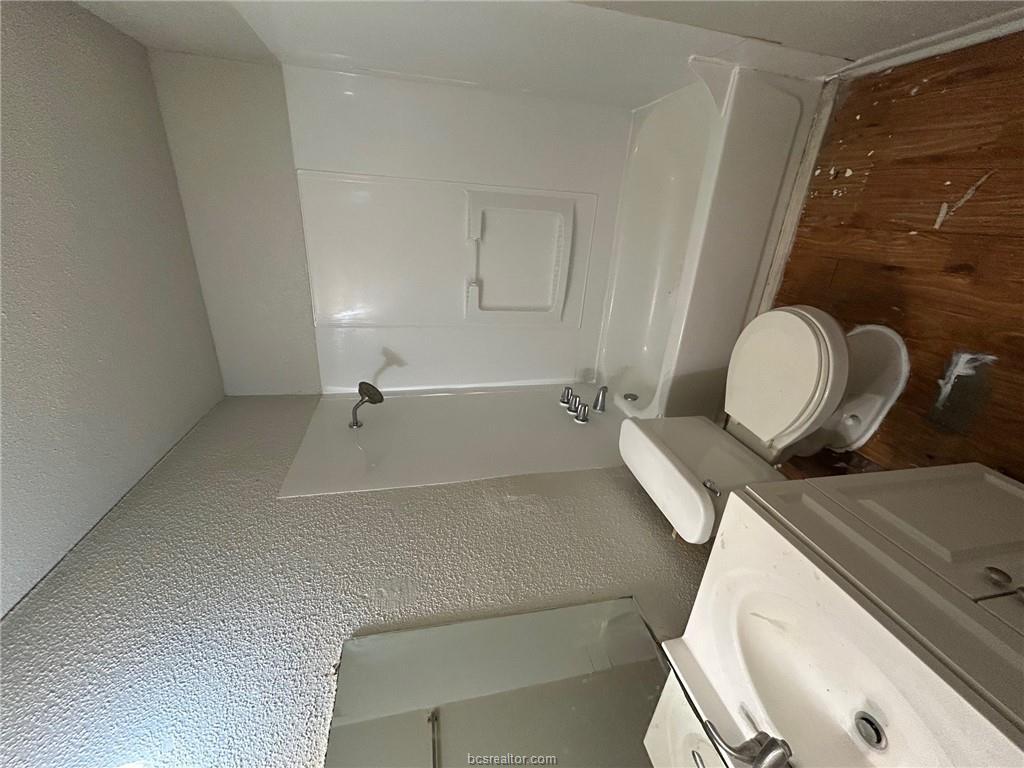 1535 Pine Ridge Drive, Unit C College Station, TX 77840 - Photo 9 of 14 a bathroom with a sink a toilet and shower