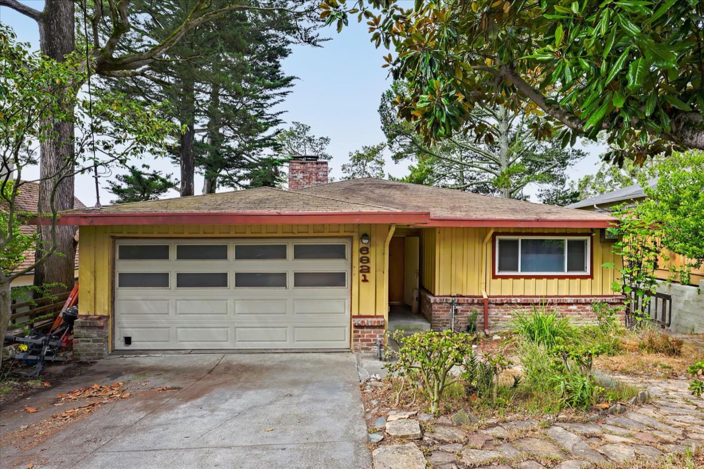 6821 Ridgewood Drive Oakland, CA 94611 - Photo 1 of 26 a front view of a house with garden