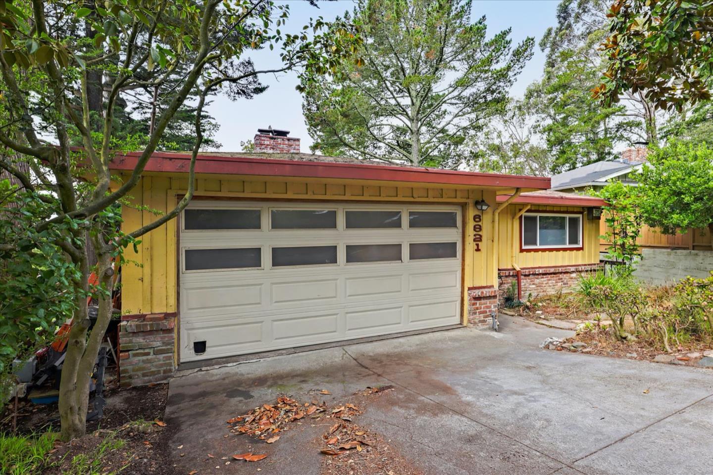 6821 Ridgewood Drive Oakland, CA 94611 - Photo 2 of 26 a small white house with a outdoor space