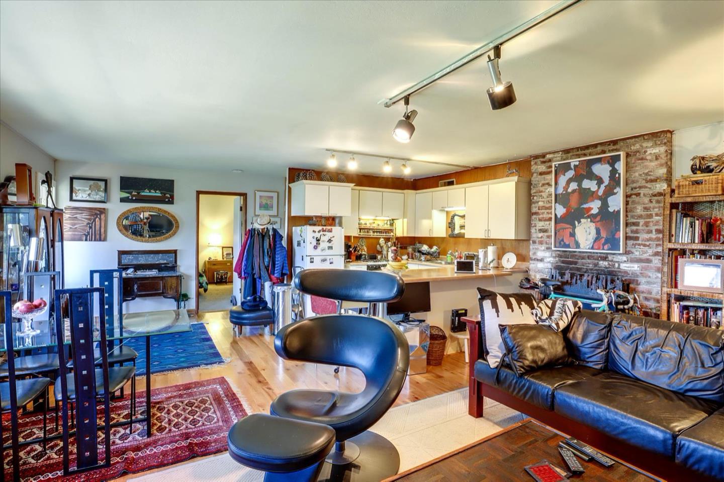 6821 Ridgewood Drive Oakland, CA 94611 - Photo 11 of 26 a living room with lots of chairs and a table