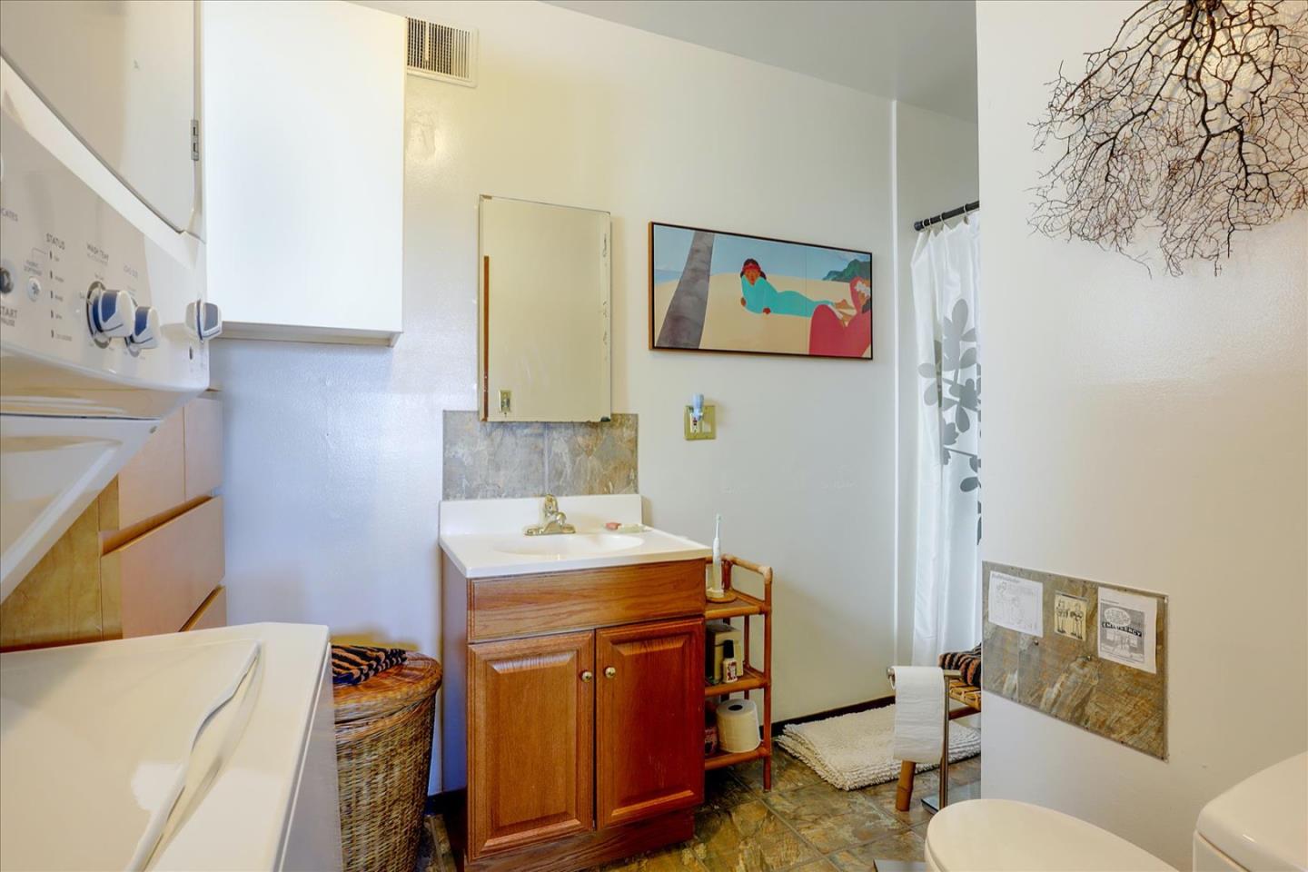 6821 Ridgewood Drive Oakland, CA 94611 - Photo 13 of 26 a utility room with a sink a washer and dryer